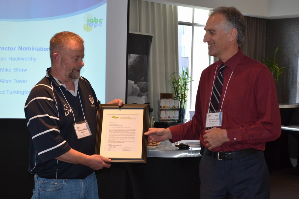 Murray McCaig (L), President of the Irrigation Industry Association of BC (IIABC) accepts the framed "Champion Supporter recognition" from Ted van der Gulik (R), President of the Partnership for Water Sustainability in BC