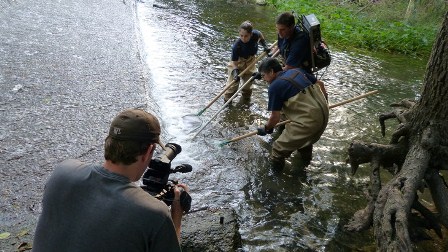 Director of photography Mark Stitzer of Penn State Public Media films scientists from the San Antonio River Authority testing for water quality. (Photo credit: Penn State Public Media)